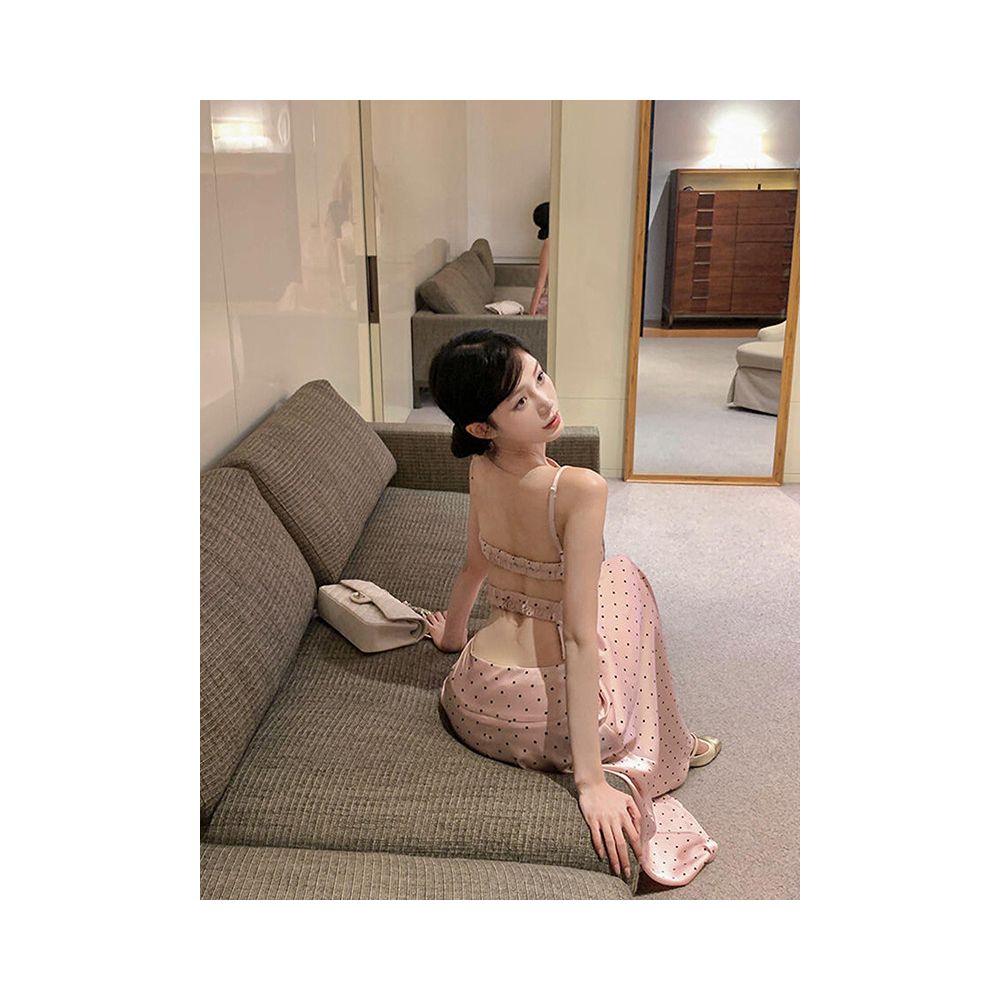 Sexy and alluring two piece women s suit featuring a pink satin polka dot backless top and skirt exuding a relaxed and elegant vibe image 1