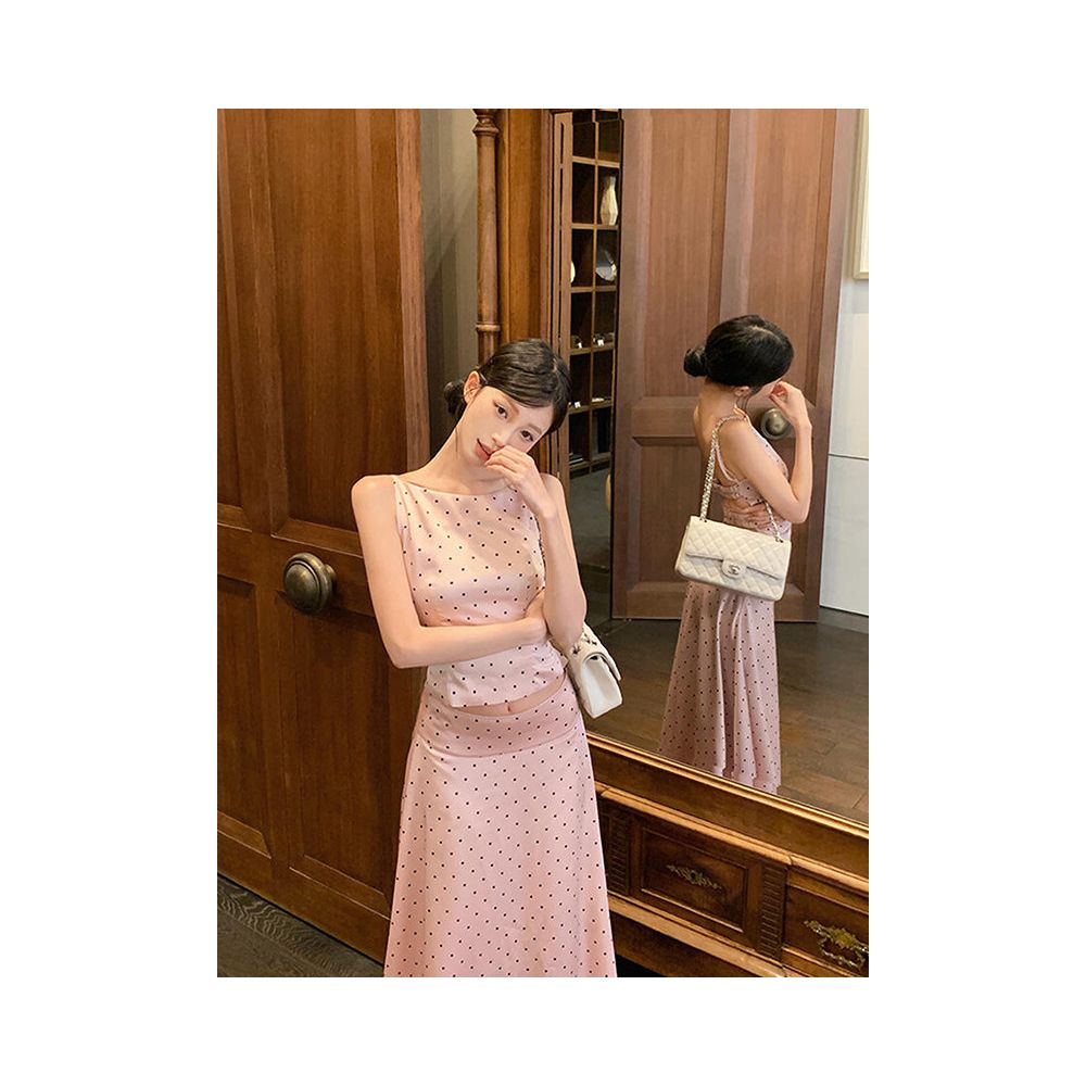 Sexy and alluring two piece women s suit featuring a pink satin polka dot backless top and skirt exuding a relaxed and elegant vibe image 2