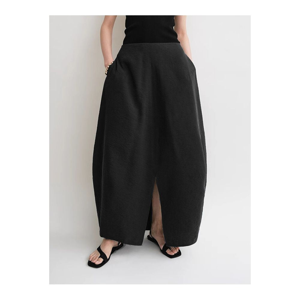 Minimalist stylish loose fitting high waisted slimming versatile silk curved midi skirt with light pleats and a slit design image 0